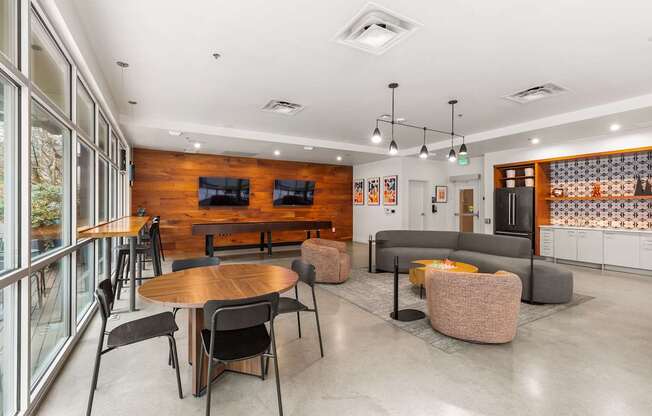 A modern dining area with a wooden table and chairs.