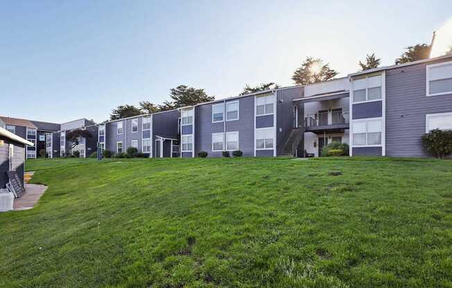 Apartment complex with green grass in front.