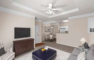 a living room filled with furniture and a flat screen tv at Creekside Apartment Homes, Kansas