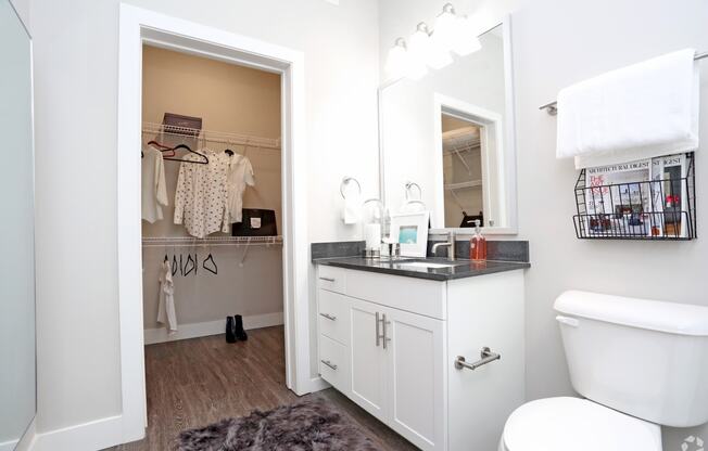 a bathroom with a vanity and a toilet and a closet at Century Baxter Avenue, Louisville, KY