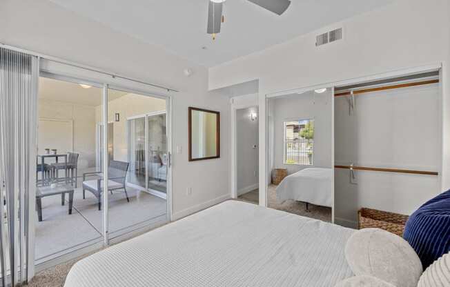 a bedroom with sliding glass doors to a patio