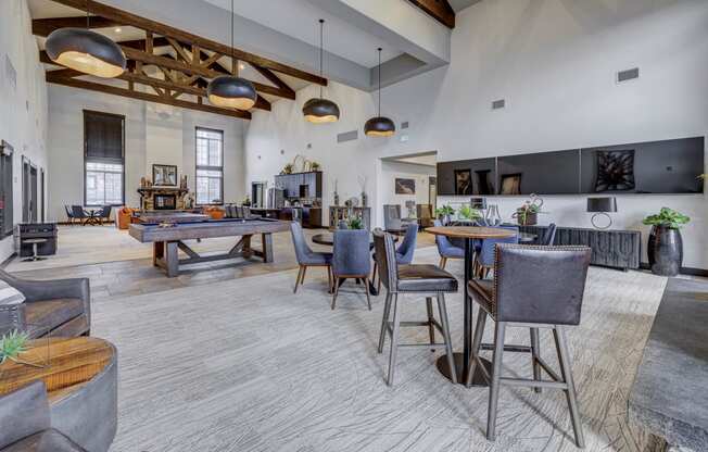 a gathering room with tables and chairs and a pool table