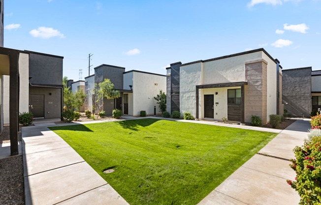 a row of houses with a lawn in front of them