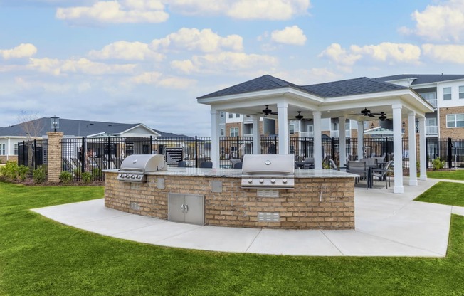 a covered patio with a grill and barbecue