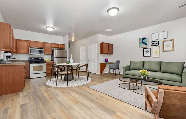 A kitchen with a dining table and chairs in the middle of the room.