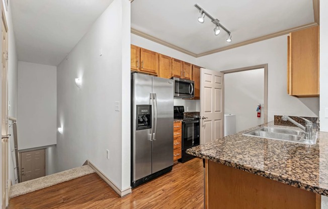 kitchen with access to stairs leading to the garage