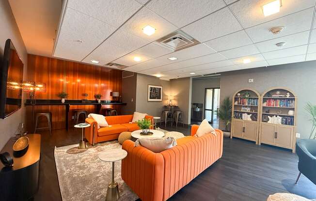 A living room with a sofa, a table, and a bookshelf.