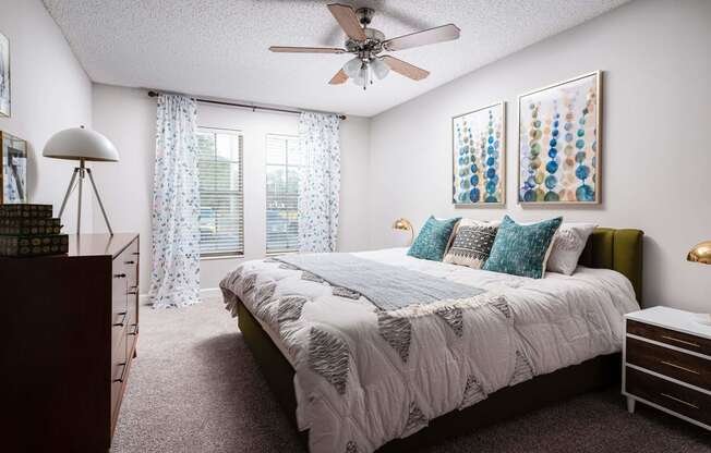 a bedroom with a bed and a ceiling fan  at The Park at Chesterfield Apartment Homes, Florida