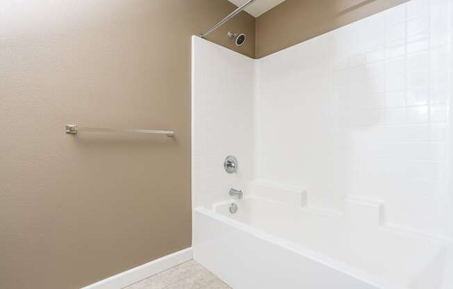 a bathroom with a tub and shower