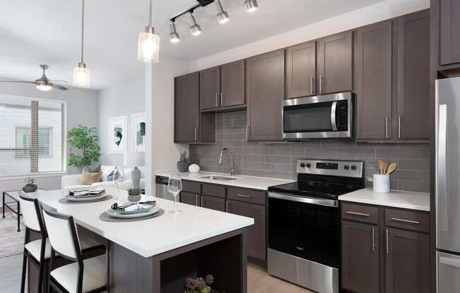 a kitchen with dark cabinets and a white island with a white countertop