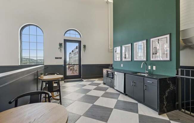 A black and white checkered floor in a room with green walls.