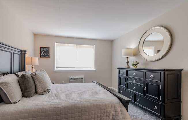 a bedroom with a bed and a dresser and a window at Glen Hollow, Croydon, Pennsylvania