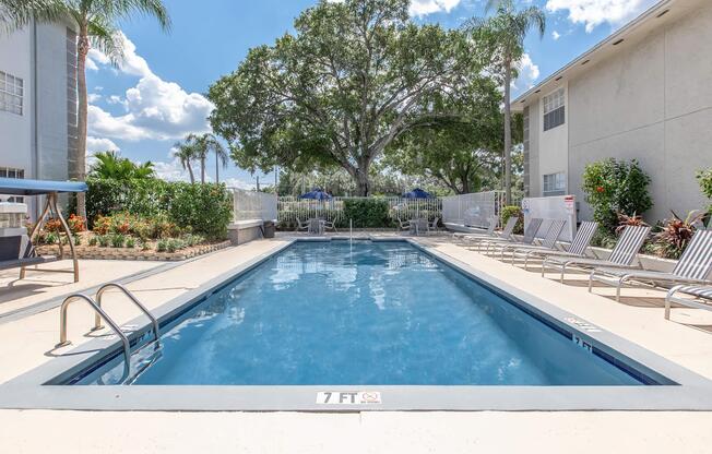 a house with a pool in front of a building