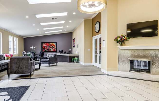 A living room with a fireplace and a painting on the wall.