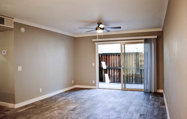 living room wot wood styled ceramic flooring and patio view with sliding glass doors