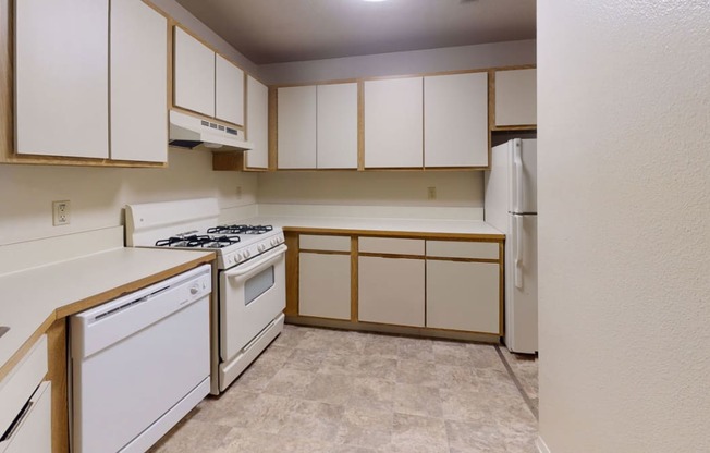 Kitchen with white appliances and stackable washer/dryer