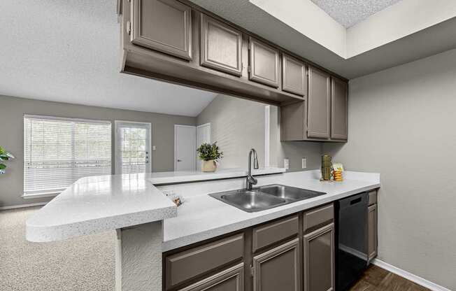 A kitchen with brown cabinets and a white countertop.