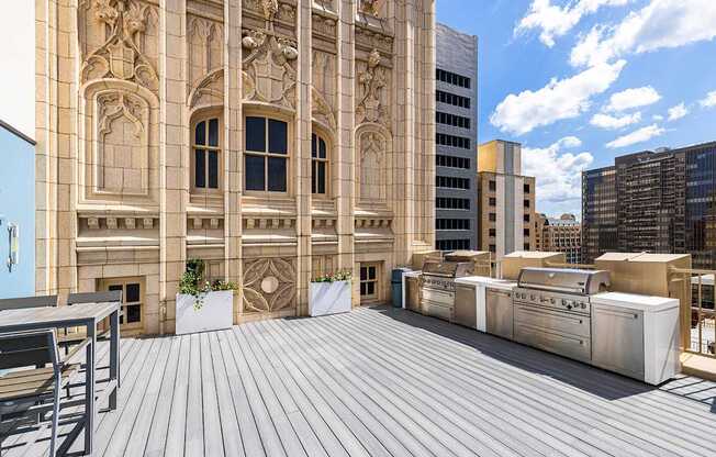 Rooftop outdoor kitchen with BBQ grills and seating - The Kirby