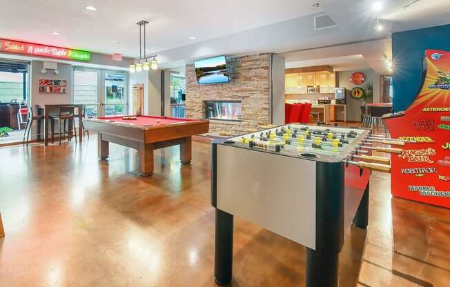 two pool tables in a game room with a bar