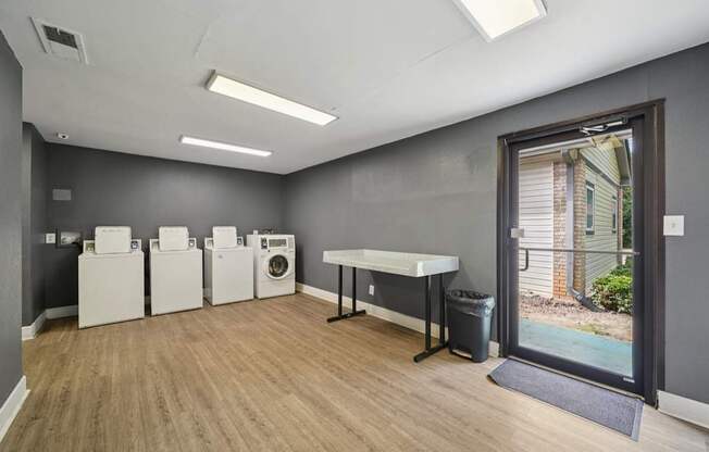 A laundry room with a washer and dryer set up next to each other.