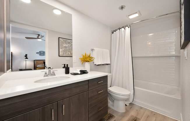 a bathroom with a sink and a shower and a toilet  at Track 281 Apartments, California, 95811