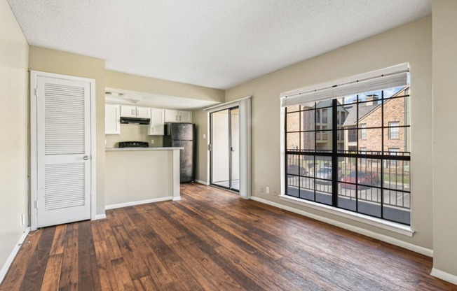 Spacious living room with large windows at Bandera Crossing apartments in San Antonio, TX