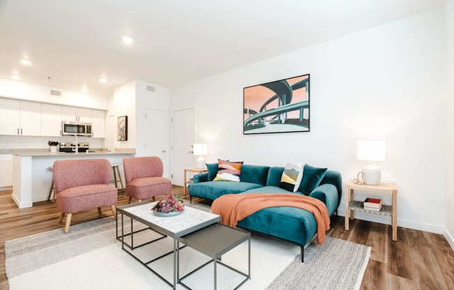 A living room with a blue couch and a coffee table.