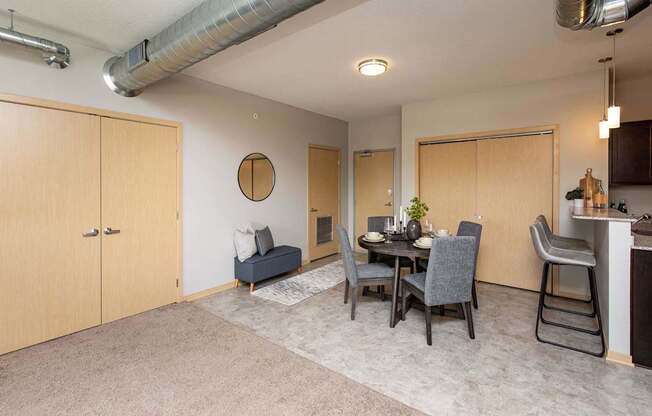 a dining room and living room with a table and chairs at Lake Shore Apartments, Iowa