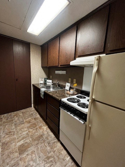 a kitchen with a stove and a refrigerator