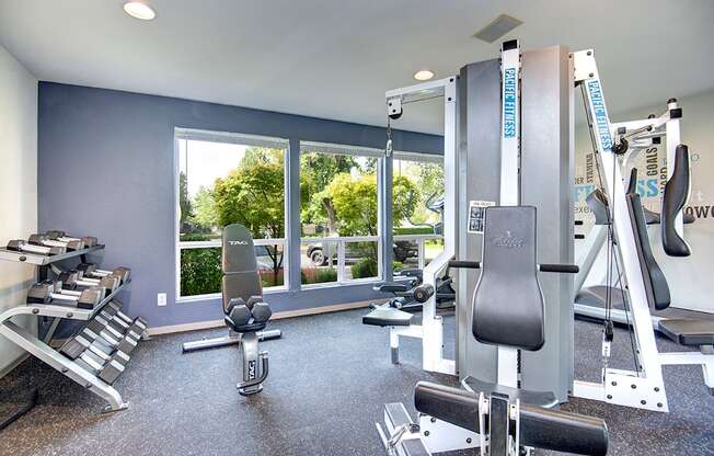 a gym with exercise equipment and a large window