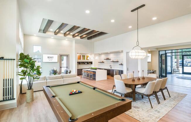 Expansive clubroom with gathering space, lounge seating, and billiards.