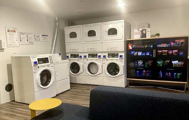 a laundry room with washers and dryers