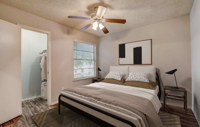 a bedroom with a bed and a ceiling fan