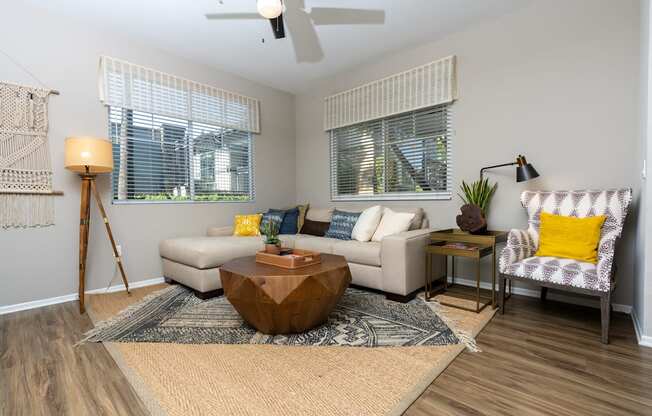 A living room with a wooden coffee table and a patterned armchair.