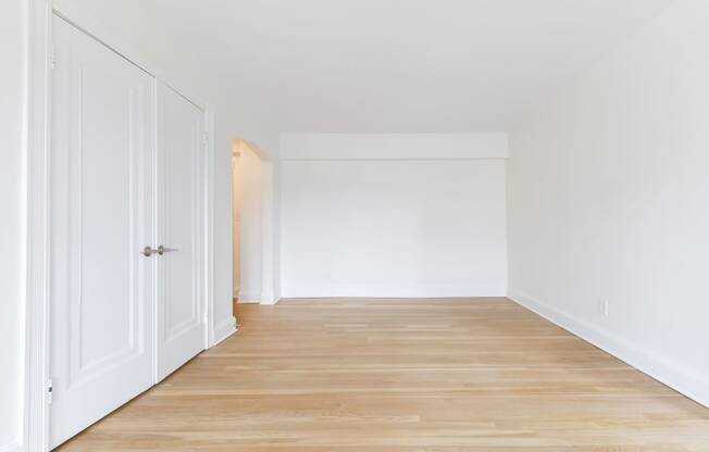 vacant bedroom with hardwood flooring at the dahlia apartments in washington dc