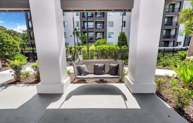 a seating area on the patio of an apartment building