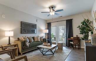 a living room with a couch and a ceiling fan