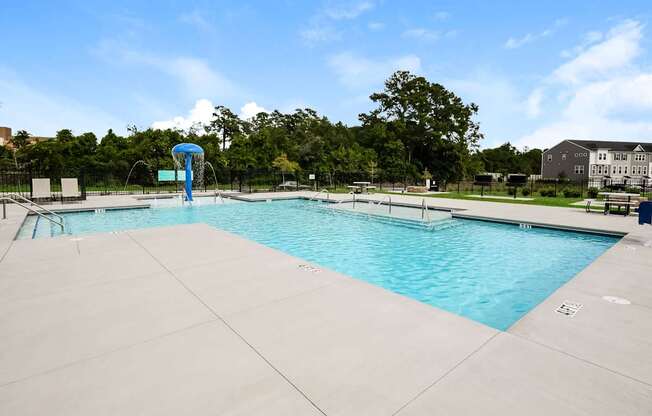 A large swimming pool with a slide in the middle.