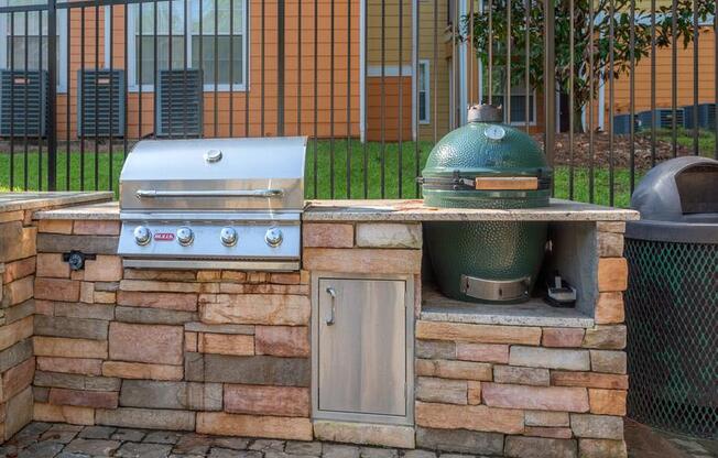 Grilling pavilion with two grills and brick designed flooring at Evergreens at Mahan apartments in Tallahassee, FL
