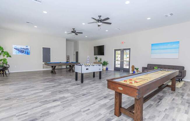 A room with a pool table and a billiard table.