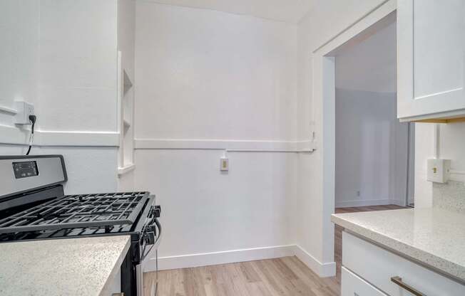 A kitchen with a stove top oven and a counter top.