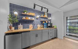 A kitchen with a blue tile backsplash and wooden countertops.