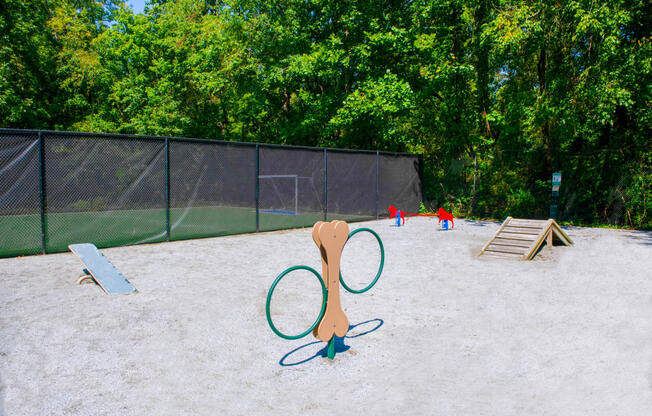 a playground with two tennis rackets and two kids playing in the background