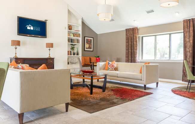 a living room with couches and chairs and a television