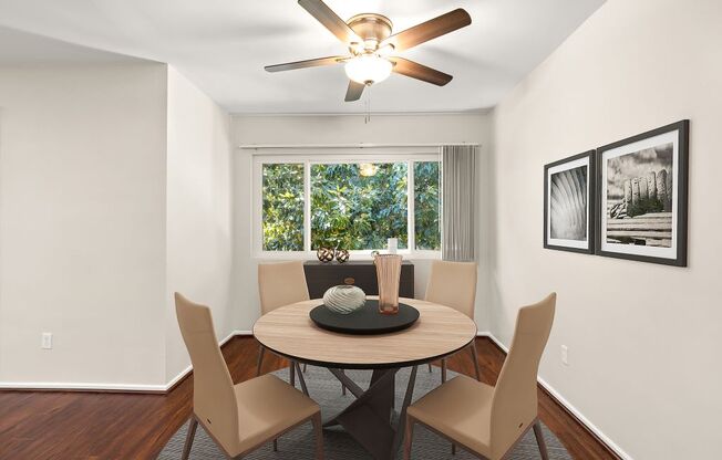 a dining room with a table and a ceiling fan
