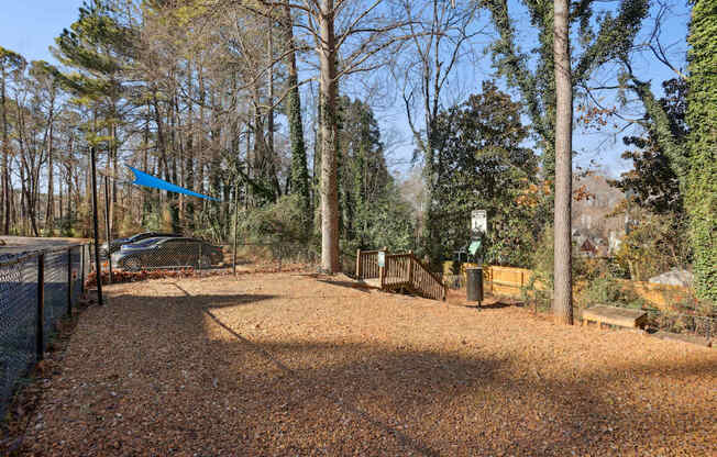 A gravel path leads through a wooded area.