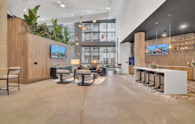 the lobby of a hotel with a lobby area and tables and chairs