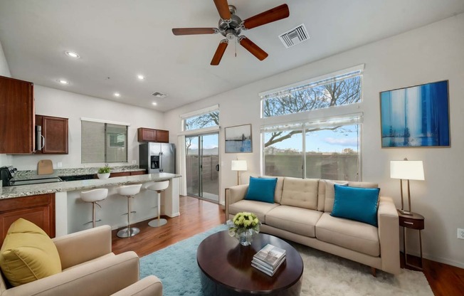 Spacious Living Room and Kitchen with Breakfast Bar at Avilla Preserve Apartment Homes in Tucson Arizona