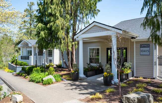 a house with a porch and a sign that reads office 105