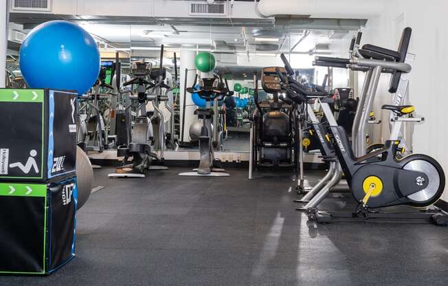 a gym with a lot of exercise machines and weights